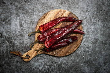 dried chili peppers  on wooden plate.