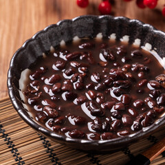 Adzuki red bean soup on wooden table background.