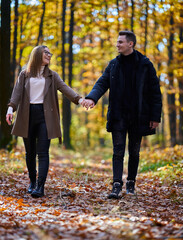 Young couple in the autumnal forest