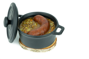 Lentil stew with sausage on white background. Copy space.