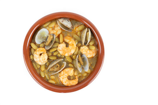 Fabas verdinas with shrimps and clams on a white background. Copy space.