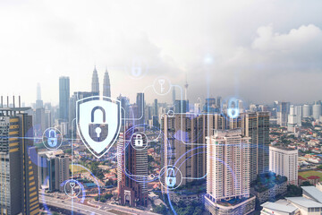 Hologram of padlock icons over panoramic city view of Kuala Lumpur to protect business, Malaysia, Asia. The concept of information security shields. Double exposure.