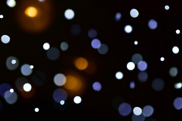 Christmas lights or bokeh in the dark background. Christmas or New Year's atmosphere. Place for your text.