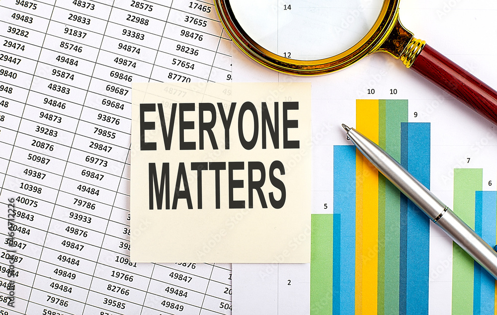 Poster business concept. top view of stiscker with text everyone matters on chart background