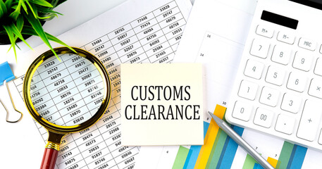 CUSTOMS CLEARANCE text on sticker on diagram with magnifier and calculator. Business concept
