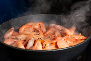 Fried shrimp on a frying pan. Healthy Sea Food, Seafood, Shrimp Cooking, Close-up. Asian Cuisine.