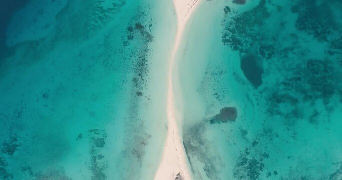 Aerial View zenith over Cayo de Agua sand isthmus . Tilt up reveal fantastic landscape tropical island.