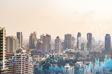 Fototapeta premium Forex and stock market chart hologram over panorama city view of Bangkok, the financial center in Southeast Asia. The concept of international trading. Double exposure.