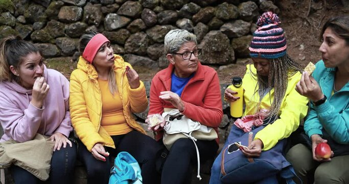 Multi generational women taking a break and having fun during trekking day