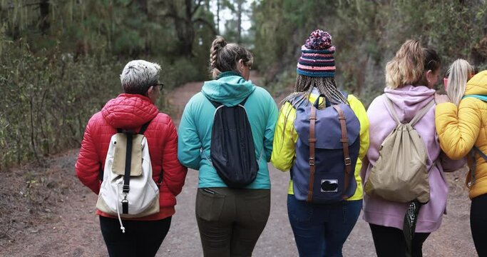Multi generational women walking outdoor having fun during trekking day - Travel concept