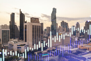Obraz premium Glowing FOREX graph hologram, aerial panoramic cityscape of Bangkok at sunset. Stock and bond trading in Southeast Asia. The concept of fund management. Double exposure.