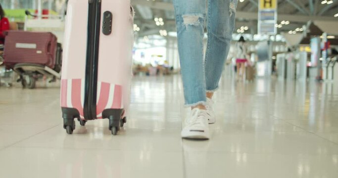 Young traveller woman walking at airport,Slow motion