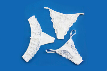 white womens lace panties on blue background