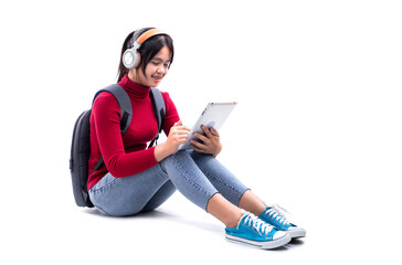 Asian teen girl listening to the music from a tablet isolated on white background. Studio shot