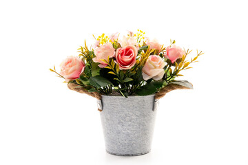 Artificial rose flowers in a bucket isolated on white background.