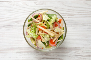 Delicious turnip salad served on white wooden table, top view