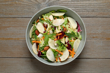 Delicious turnip salad served on wooden table, top view