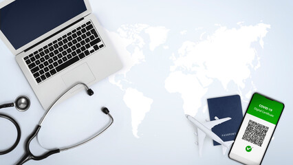 Green pass covid-19 vaccination concept for travel. Passport, airplane, stethoscope and laptop...