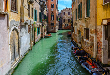 Narrow canal with gondola in Venice, Italy. Architecture and landmark of Venice. Cozy cityscape of Venice.