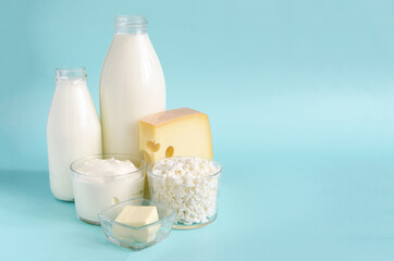 Milk products - advertising on a light background . Milk, kefir, sour cream, cheese, butter and...