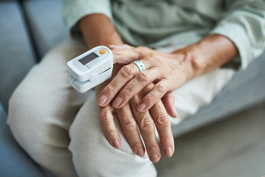 Close up of unrecognizable senior woman measuring oxygen saturation, copy space