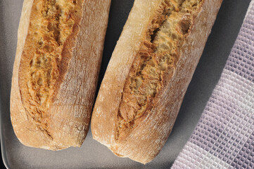 two mini baguettes on a black background - French cuisine
