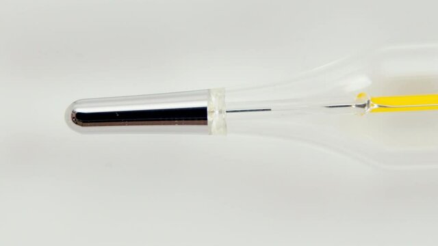 Glass Mercurial Thermometer On A White Background