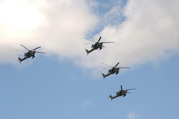 The Golden Eagles aerobatic team on Mi-28N attack helicopters in the sky over Moscow's Red Square during the dress rehearsal of the Victory Air Parade