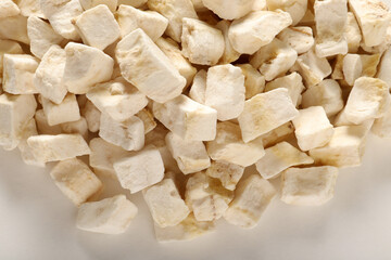 freeze dried cubed banana on a white background