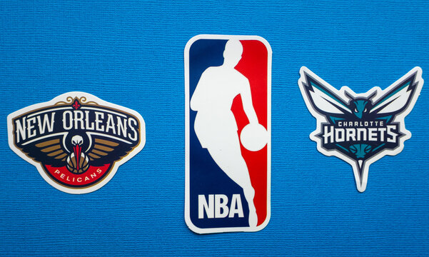 October 1, 2021, Springfield, USA, Emblems of the Charlotte Hornets and New Orleans Pelicans basketball teams on a blue background.