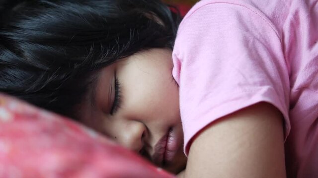 close up of child girl's eye sleeping on bed.