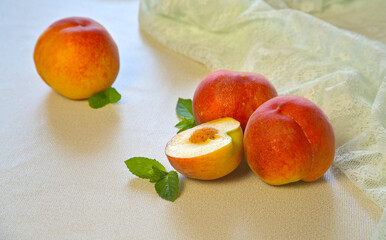 Closeup of cut fresh peaches, mint, delicious and nutritious fruit
