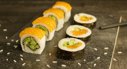 Closeup of salmon sushi on the black wooden board, Japanese cuisine