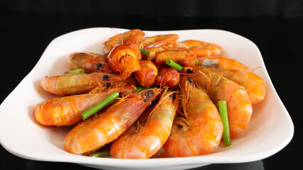 Close-up golden oil stuffed prawns on the black table, delicious seafood