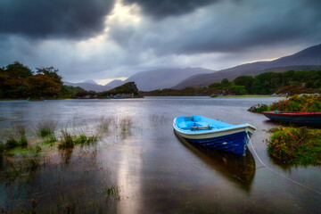 Beautiful scenery of the Killarney lake with boat at dusk, County Kerry. Ireland