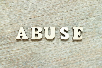Alphabet letter in word abuse on wood background
