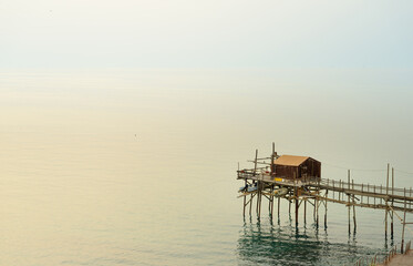 the trabucco is a fishing net winching mecanism mounted on stilts with a wood bridge, a heritage...