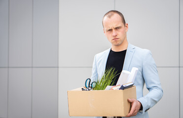 Portrait of a young man who lost his job. He doesn't know what to do, he is stressed. Unemployment rate growing.