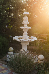 Fountain in the shape of a cherub angel sunset lavender