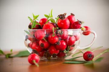ripe red rose hips on a wooden table