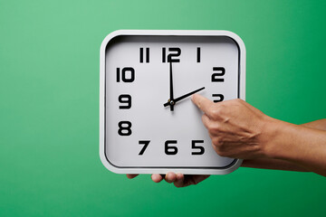 man sets a clock backward