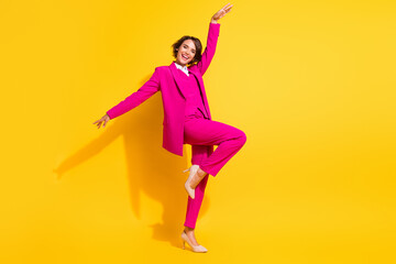 Fototapeta na wymiar Photo of adorable cute young lady wear pink suit smiling dancing isolated yellow color background