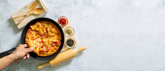 Pizza in pan,Fresh raw pizza with mushrooms, cherry tomatoes , Basil and Parmesan in a round pan on a white background with copy space. Homemade pizza before baking