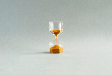 Hourglass , symbol of time on grey background. The movement of time. Time boundaries. Measurement...