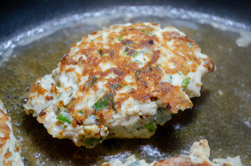 fried chicken mince patties with green on the blue iron pan top view