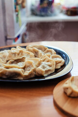 Homemade meat dumplings - russian pelmeni. Dumplings, filled with meat, ravioli. Dumplings with filling. Close-up.