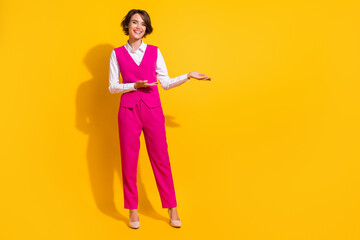 Full body photo of cute millennial brunette lady point wear pink suit stilettos isolated on yellow background