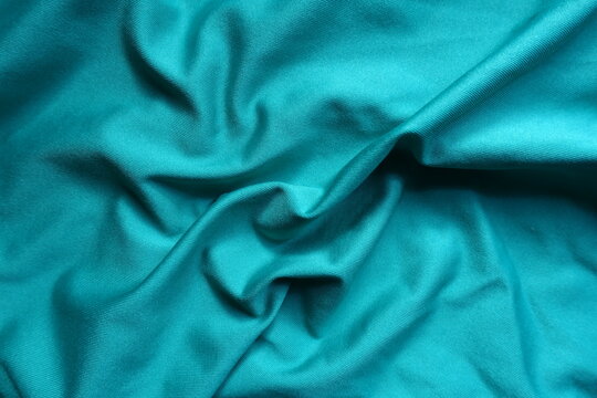 Draped blue green polyester fabric from above