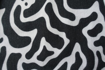 Surface of black and white cotton jersey fabric from above