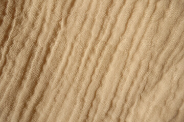 Background - beige muslin cotton fabric from above